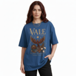 Front view of a female model wearing a VALE Nature's Legacy oversized cotton t-shirt featuring a phoenix and floral graphic design in Maroon, Blue, and White.