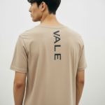 Back view of a man wearing a Terracotta VALE slim-fit t-shirt with a vertical black logo on the spine
