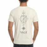 Back view of a man wearing a VALE brand 100% cotton breathable T-shirt featuring a black geometric compass and celestial line-art design.