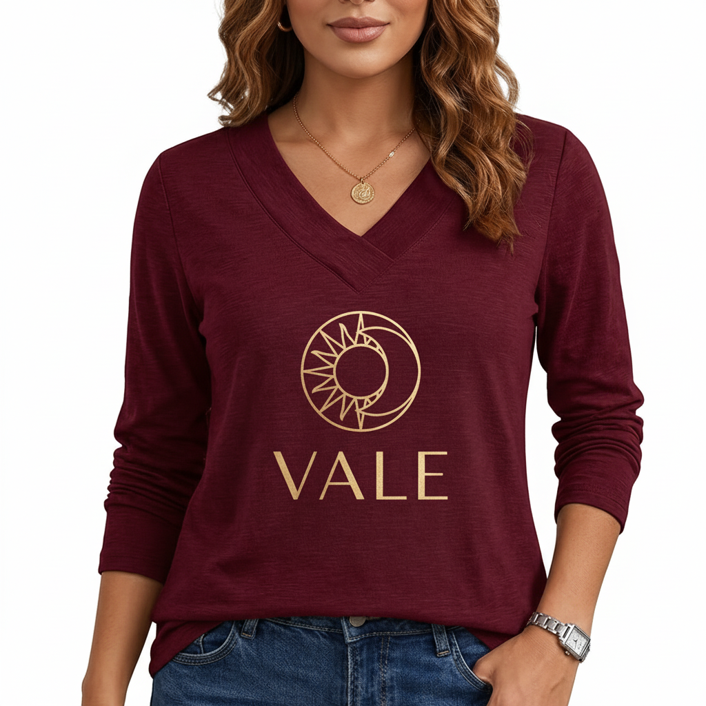 Minimalist Sun & Moon Design V-Neck Shirt Front view of a woman wearing a VALE brand long sleeve V-neck cotton shirt featuring a gold celestial sun and moon logo, available in maroon, brown, and orange.