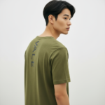 Back view of a man wearing a Terracotta VALE slim-fit t-shirt with a vertical black logo on the spine