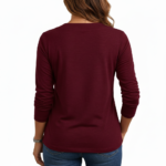 Women's long-sleeve V-neck cotton shirt featuring a gold VALE celestial sun, moon, and floral graphic design.