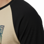 Man wearing a VALE Art Deco graphic raglan shirt made of breathable cotton with 3/4 sleeves.