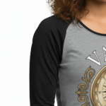 Woman wearing a breathable cotton raglan 3/4 sleeve shirt featuring a vintage nautical compass "VALE" graphic design, available in Grey/Black, White/Grey, and Olive/Black colorways.