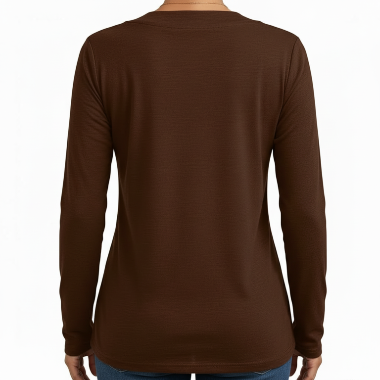 Front view of a woman wearing a VALE brand long sleeve V-neck cotton shirt featuring a gold celestial sun and moon logo, available in maroon, brown, and orange.