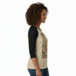 Woman wearing a VALE Art Deco graphic raglan shirt made of breathable cotton with black 3/4 sleeves, available in cream, maroon, and grey.