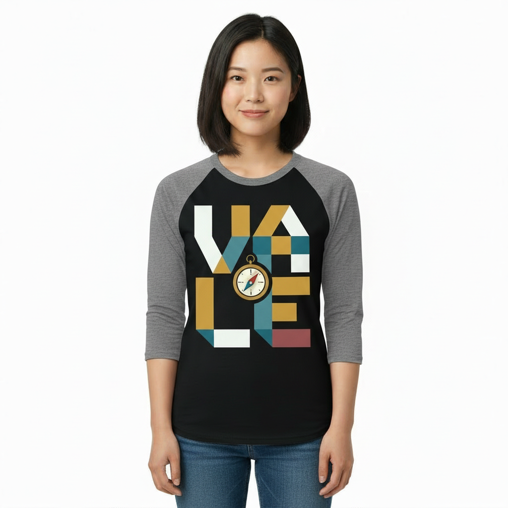 A woman wearing a breathable cotton raglan baseball shirt featuring a colorful geometric "VALE" logo and a central compass graphic. Available in Maroon, Grey, and Olive Green sleeves with a black or burgundy torso.