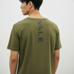 Back view of a man wearing a Terracotta VALE slim-fit t-shirt with a vertical black logo on the spine