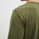 Back view of a man wearing a Terracotta VALE slim-fit t-shirt with a vertical black logo on the spine
