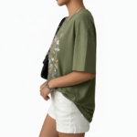 Front view of a woman wearing an oversized breathable cotton t-shirt with a vintage wildflower graphic print, available in blue, green, and orange.