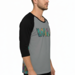 Men's VALE patchwork raglan shirt in white, grey, and cream with black and brown 3/4 sleeves, featuring decorative textured lettering.