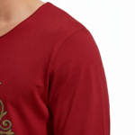 "Man wearing a VALE brand long sleeve cotton shirt featuring a vintage gold nautical compass graphic on the chest, available in black, forest green, and burgundy."