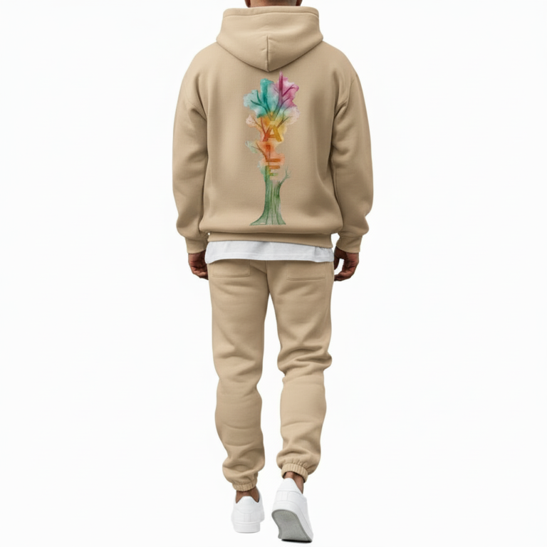 A man wearing a premium breathable cotton tracksuit featuring a colorful watercolor tree graphic with "VALE" text on the back, available in Black, Burgundy, and Sand.