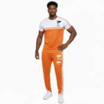 Man wearing VALE brand two-tone cotton tracksuit set in orange, red, and green with white accents and "key in hand" logo.