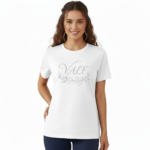A female model showcasing the VALE branded floral graphic t-shirt in Navy Blue, Black, and White. 100% breathable cotton fabric featuring a silver script logo and elegant floral wreath design on a clean white background.