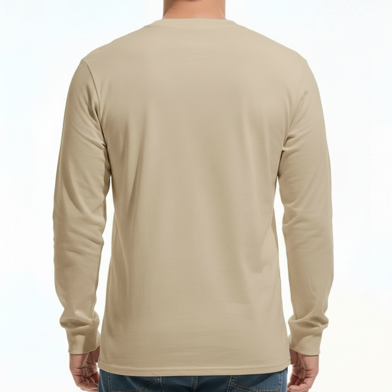 A man wearing a VALE Traveler’s Goods long-sleeve cotton shirt featuring a vintage-style gold and cream graphic label that says "Bound for Adventure" on the chest.