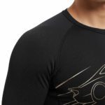 Front view of a man wearing a VALE brand 2-piece compression suit with a gold supercar graphic on the long-sleeve shirt and leggings, available in olive green, navy blue, and maroon.