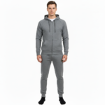 Rear and front view of a man wearing a VALE brand cotton tracksuit featuring a gold-foil vintage car and tree branch design on the back and vertical logo on the leg, shown on a white background.