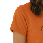 Woman wearing a VALE brand graphic t-shirt in breathable cotton, featuring a minimalist leaf design and athletic slim fit. Available in Black, Purple, and Orange.