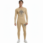Front view of a man wearing VALE brand 2-piece compression suits in multiple colors including white, navy, orange, and yellow, featuring signature gold side-logos and central compass graphics on breathable cotton-blend fabric.