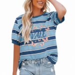 A smiling model wearing a breathable VALE brand cotton t-shirt with horizontal stripes, featuring a central butterfly graphic design and puff sleeves, paired with light-wash distressed denim jeans against a clean white background.