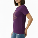 Female model wearing a Vale Limited Edition floral graphic t-shirt made of breathable cotton, featuring copper metallic flower design and script lettering.