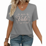 A woman wearing a breathable cotton V-neck T-shirt with a "Vale" butterfly graphic design, available in brown, green, and grey.