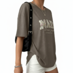 Flat lay and model view of women's oversized "MADE Pure Joy" floral graphic t-shirt in dusty brown, slate blue, and sage green.