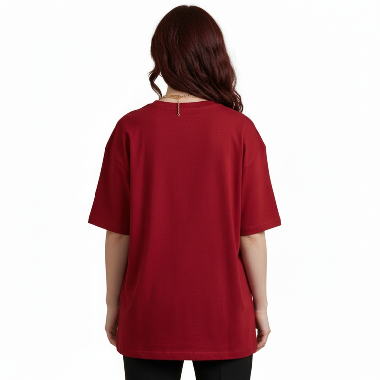 Front view of a female model wearing a VALE Nature's Legacy oversized cotton t-shirt featuring a phoenix and floral graphic design in Maroon, Blue, and White.