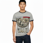 Front view of a man wearing a VALE brand steampunk graphic t-shirt featuring internal watch gears and cogs design, 100% cotton breathable fabric, available in Olive, Grey, and White.