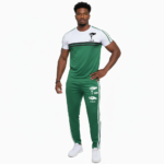 Man wearing VALE brand two-tone cotton tracksuit set in orange, red, and green with white accents and "key in hand" logo.