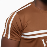 Man wearing VALE brand breathable cotton tracksuit with short-sleeve t-shirt and matching joggers in earth tones.