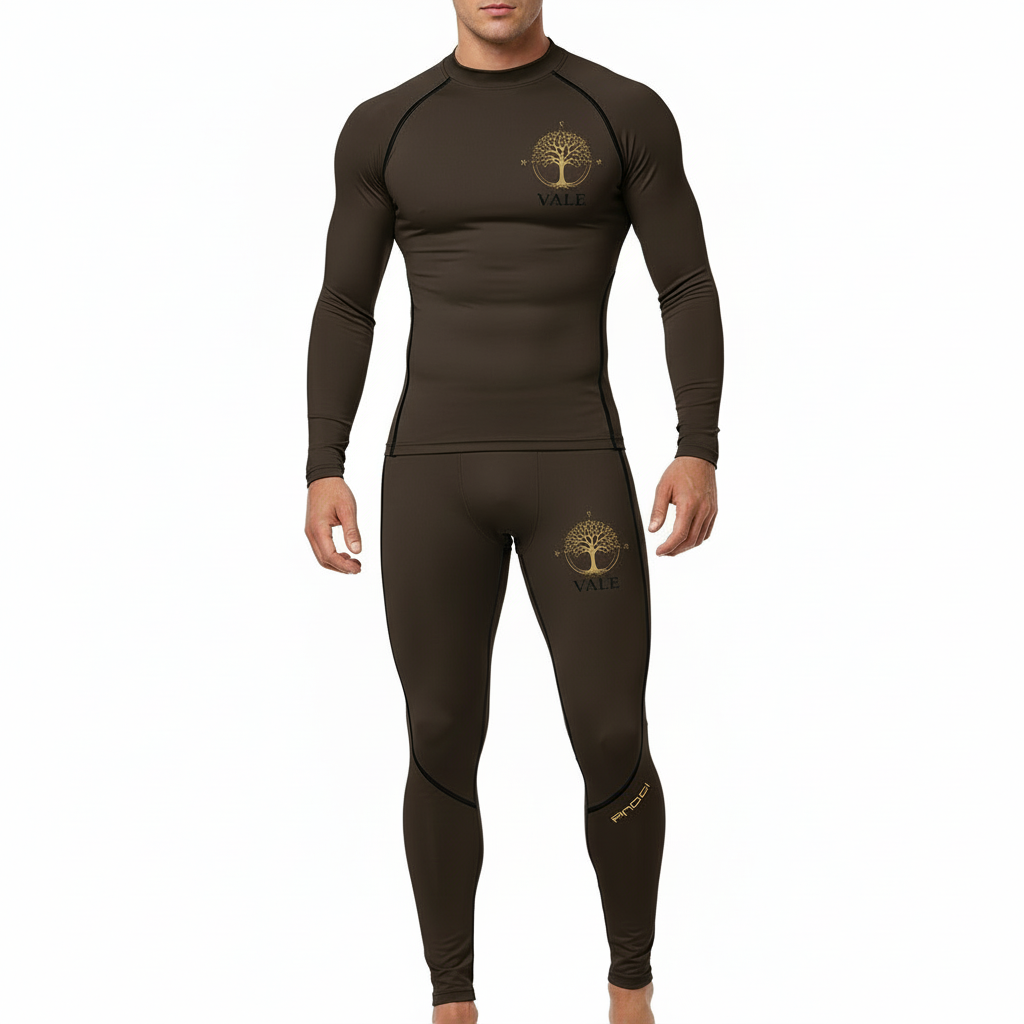 Front view of a man wearing a VALE brand 2-piece compression suit featuring a gold Tree of Life mandala graphic on the long-sleeve top and matching leggings, shown in brown, olive green, and grey colors.
