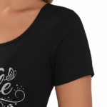 Close-up of a woman wearing a breathable ribbed cotton t-shirt featuring a glittery "Vale" graphic design with floral accents.