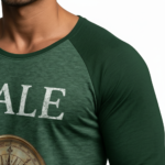 Men's 3/4 sleeve raglan baseball shirt in breathable cotton featuring a vintage VALE text and nautical compass graphic, athletic slim fit.