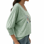Women's breathable cotton VALE graphic top with floral lettering and smocked puff sleeves.