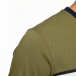 Front view of a man wearing a VALE brand steampunk graphic t-shirt featuring internal watch gears and cogs design, 100% cotton breathable fabric, available in Olive, Grey, and White.