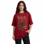Front view of a female model wearing a VALE Nature's Legacy oversized cotton t-shirt featuring a phoenix and floral graphic design in Maroon, Blue, and White.