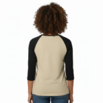 Woman wearing a VALE Art Deco graphic raglan shirt made of breathable cotton with black 3/4 sleeves, available in cream, maroon, and grey.