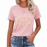 Woman wearing a breathable cotton t-shirt with a floral butterfly "VALE" graphic design on the chest, available in pink, red, and brown colors.