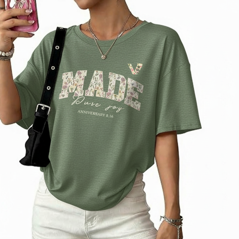Flat lay and model view of women's oversized "MADE Pure Joy" floral graphic t-shirt in dusty brown, slate blue, and sage green.
