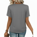 Woman wearing a "Vale" floral print V-neck cotton t-shirt with a chest pocket, available in blue, red, and grey.