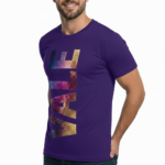 A man wearing a slim-fit 100% cotton t-shirt with a vertical 'VALE' graphic in a vibrant purple, gold, and blue metallic texture.