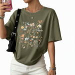 Front view of a woman wearing an oversized breathable cotton t-shirt with a vintage wildflower graphic print, available in blue, green, and orange.