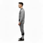 Full-body studio mockup of a man wearing a VALE brand breathable cotton tracksuit featuring a hand-passing-a-key graphic and ink-splatter design, available in grey, brown, and white-black contrast.