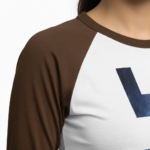 Person wearing a 3/4 sleeve raglan cotton shirt featuring a vertical VALE galaxy-textured graphic print.