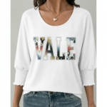 Women's breathable cotton VALE graphic top with floral lettering and smocked puff sleeves.