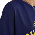 Woman wearing a breathable cotton oversized t-shirt with "Sunshine and Beach" yellow graphic print, available in navy blue, maroon, and red.