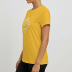 Women wearing VALE brand cotton graphic t-shirt with white filigree mandala design, available in blue, mustard, and cream.