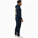 Man wearing a textured breathable cotton tracksuit with a vintage traveler's badge on the back, available in Obsidian Navy, Forest Green, and Heather Charcoal.